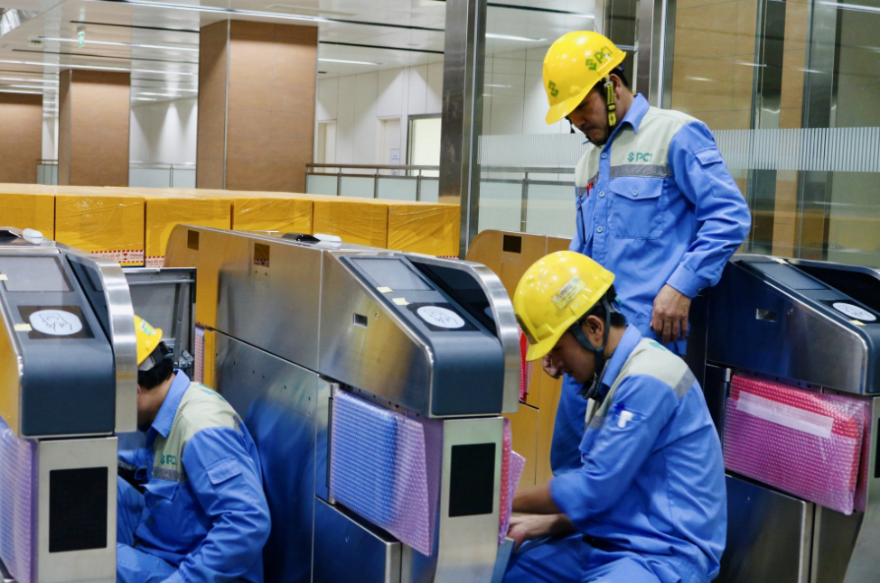Engineers inspect the ticket checking system at the underground Opera House metro station of the first metro line in Ho Chi Minh City. Photo: MAUR