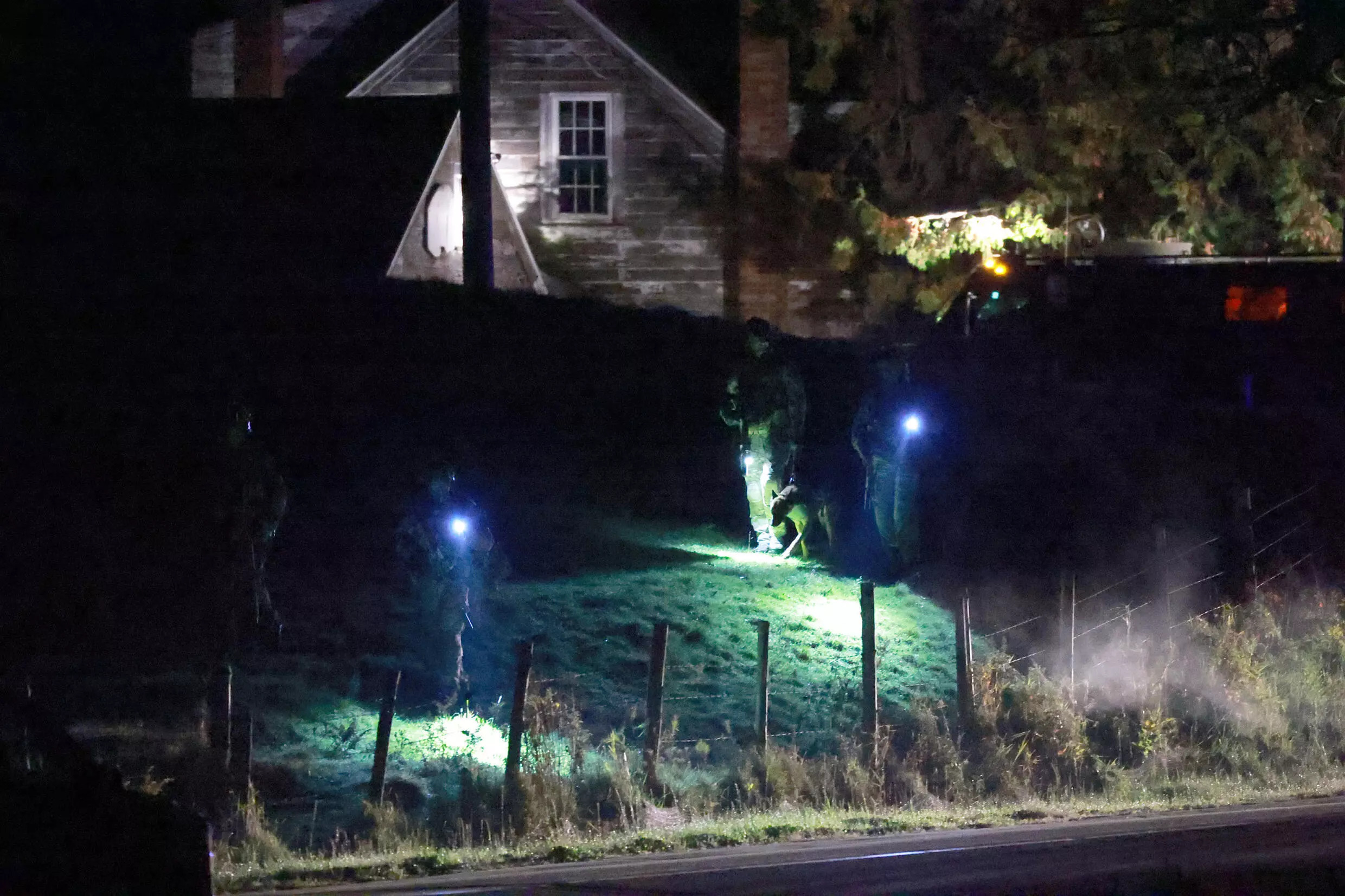 Law enforcement officials search an area at the family home of suspect Robert Card on October 26, 2023 in Bowdoin, Maine. Photo: AFP