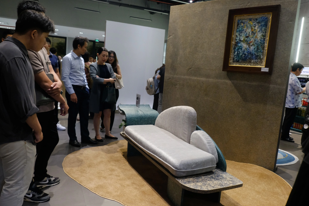 Visitors take a look at a furniture product made from discarded plastic bags. Photo: Vu Thuy / Tuoi Tre